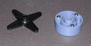 The unmodified servo bracket on the left and the unmodified clutch on the right