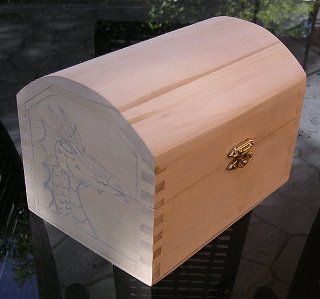 Dragon tracing on the side of a small wooden chest for wood carving.