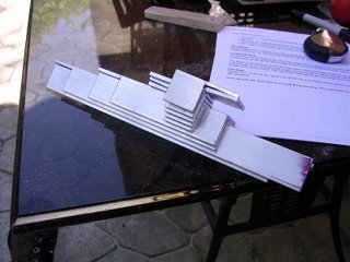 Stacked aluminum brackets.