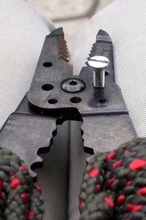 Wire cutters cutting a bolt