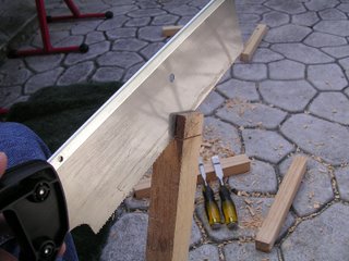 cutting a wood tenon joint with a handsaw